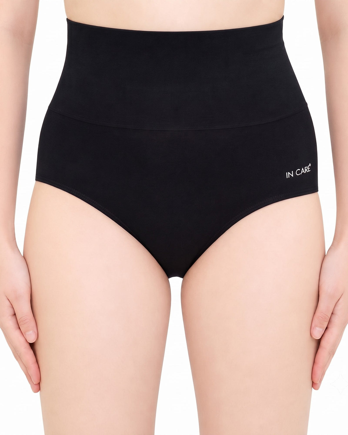 Black high waist tummy control shapewear panty with a tall broad elastic waistband, front view on a model