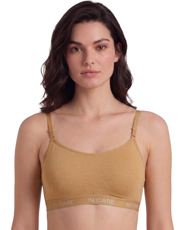 Tan non-padded slip-on sports bra with In Care band, wire-free, front view on a model